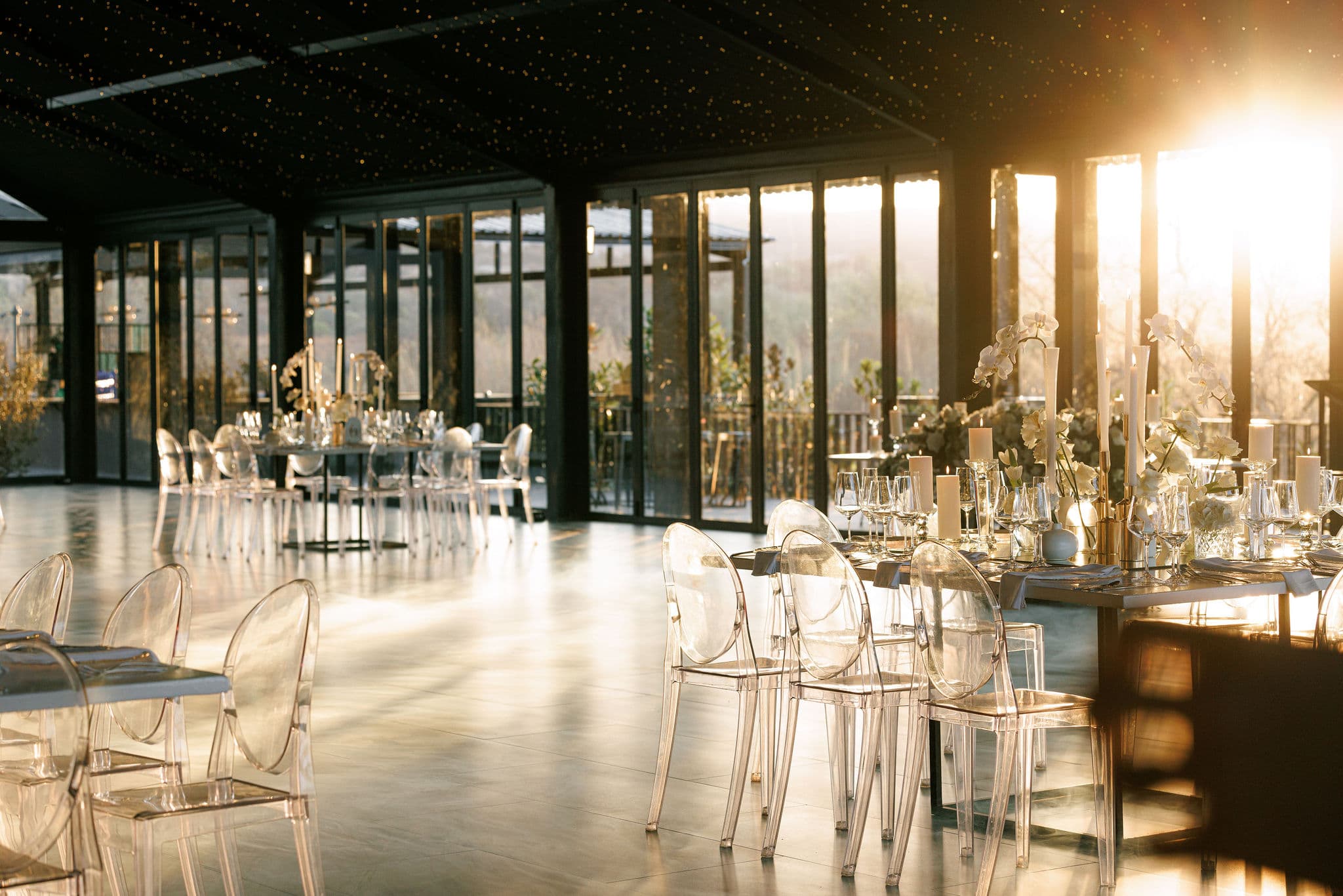 Golden hour light through the glass walls of the reception hall at Inimitable